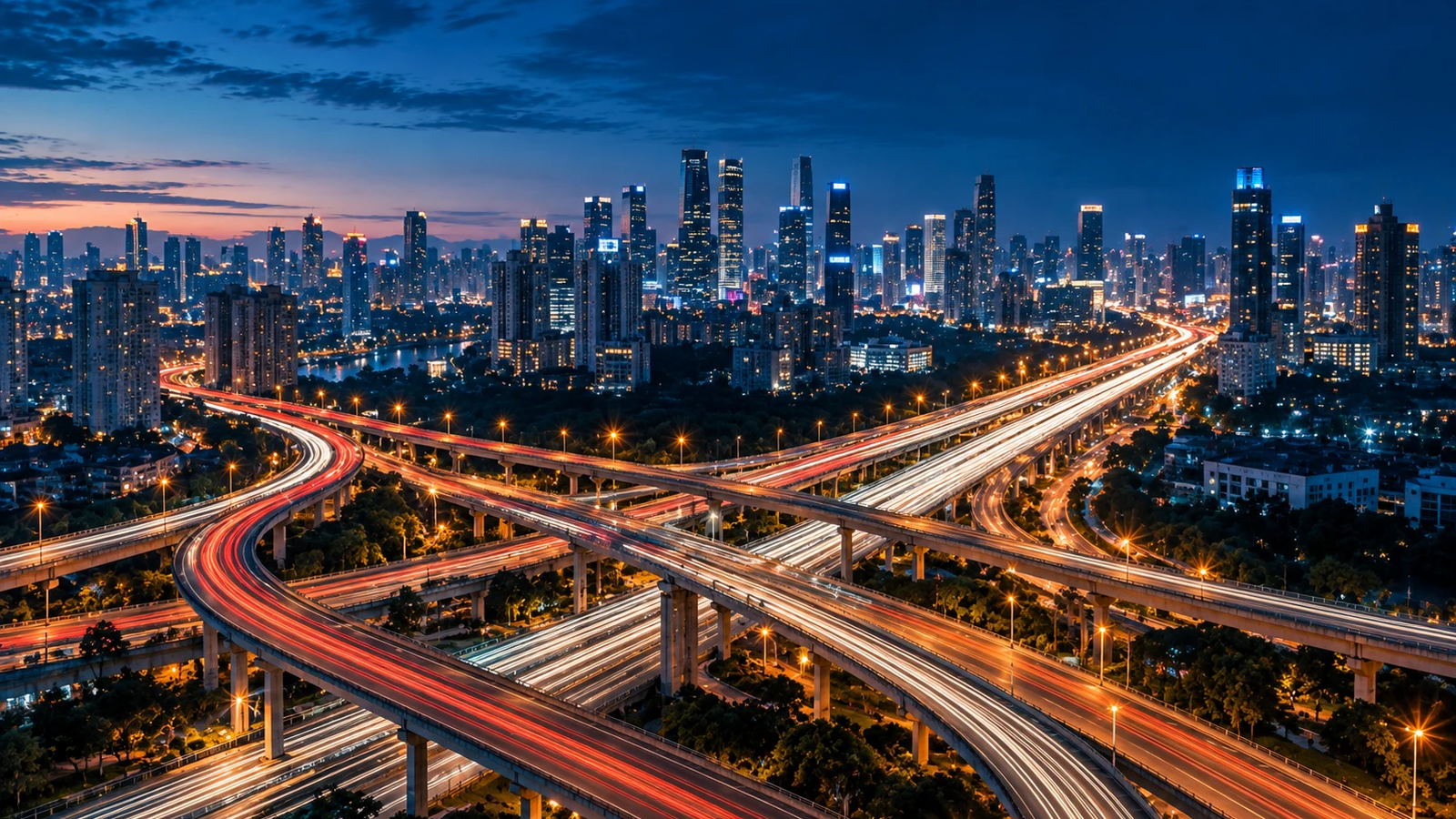 City interchange at night with flowing traffic light trails